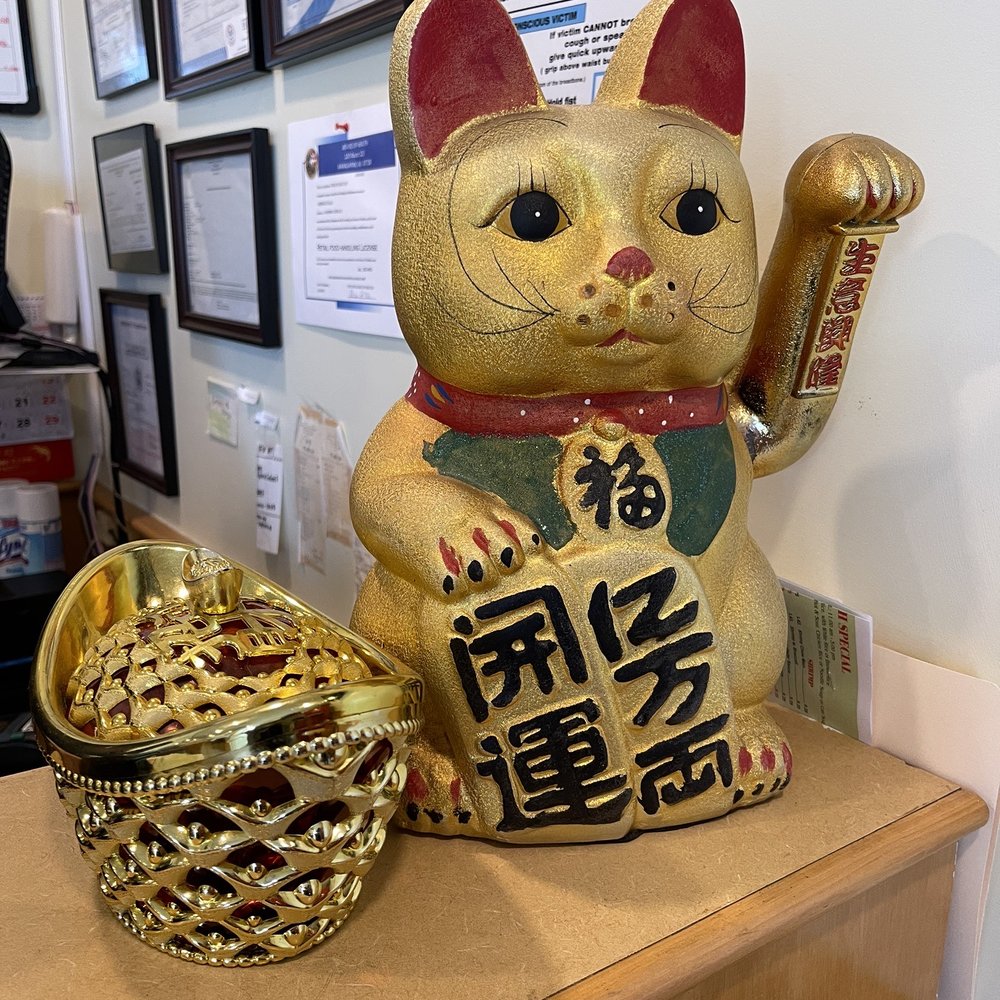 a cat statue and a bowl a cat statue and a bowl