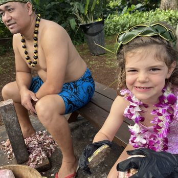 Toa Luau - Our granddaughter working on scraping tarot root with the "cousin." - Cultural Center Near Me - Haleiwa, Hawaii Toa Luau - Our granddaughter working on scraping tarot root with the "cousin." - Cultural Center Near Me - Haleiwa, Hawaii