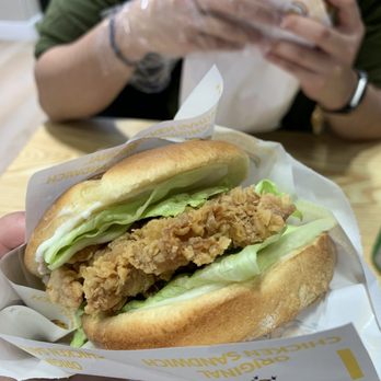 Super Chicken - a person holding a sandwich in their hand - Chicken Shop Near Me - Mississauga, Ontario
