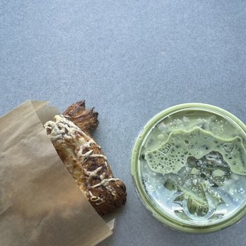 Peixoto Coffee - Toasted coconut oat milk matcha latte with a pizza pastry - Coffee Roasteries Near Me - Gilbert, Arizona