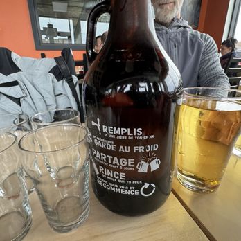 La Veillée - a man sitting at a table with a bottle of beer - Beer, Wine & Spirits Near Me - Sainte-Agathe-des-Monts, Quebec La Veillée - a man sitting at a table with a bottle of beer - Beer, Wine & Spirits Near Me - Sainte-Agathe-des-Monts, Quebec
