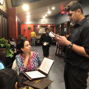 Adyar Ananda Bhavan - Our waiter, the table next to us, and the front dining room - Indian Near Me - Parsippany, New Jersey Adyar Ananda Bhavan - Our waiter, the table next to us, and the front dining room - Indian Near Me - Parsippany, New Jersey