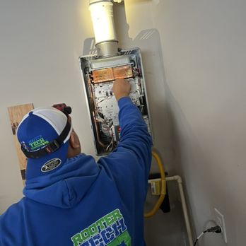 Rooter Tech - Our Technician working on a Tank less water heater. - Plumbing Near Me - Tacoma, Washington