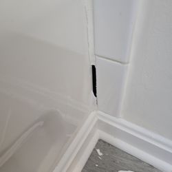 Three Rivers Builders - My tub bathroom area where they left cracked tile Three Rivers builders and
