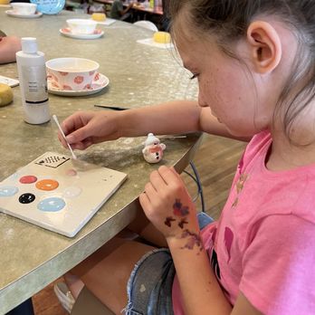 Petroglyph Ceramic Lounge - Grand daughter w/ her Xmas creation. - Paint-Your-Own Pottery Near Me - Roseville, California