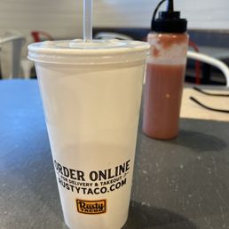 a plastic cup with a straw in it a plastic cup with a straw in it