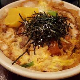 Donkatsu pork cutlet with egg and onions over rice Donkatsu pork cutlet with egg and onions over rice