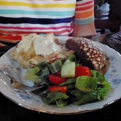 FPH Bakery - Spinach Ravioli served with bread and a side salad on a real china plate.