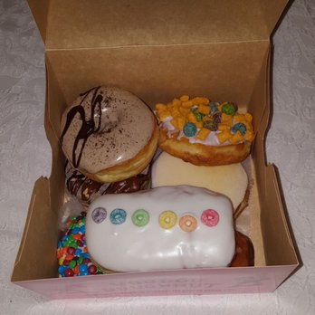 Voodoo Doughnut - Noussa, Captain Crunch, & Gay bar on top. Chuckles, Mango Tango, M&M and Milk bar burried underneath ! - Donuts Near Me - Denver, Colorado