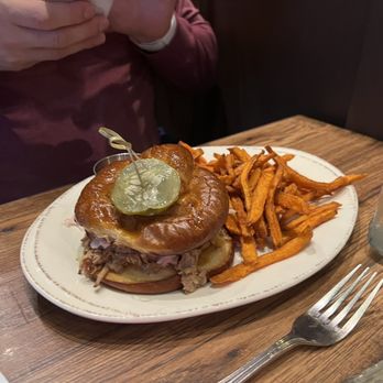 Freebird Kitchen and Bar - Pulled pork sandwich on pretzel bun with sweet potatoe fries - Southern Near Me - White Plains, New York Freebird Kitchen and Bar - Pulled pork sandwich on pretzel bun with sweet potatoe fries - Southern Near Me - White Plains, New York