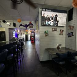 Eliza’s Bar & Grill - From bar facing slot machine gaming area, rear exit, and restrooms