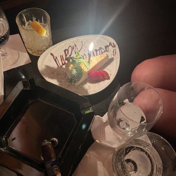 Club Macanudo - a birthday cake with a lit candle - Lounges Near Me - New York, New York Club Macanudo - a birthday cake with a lit candle - Lounges Near Me - New York, New York