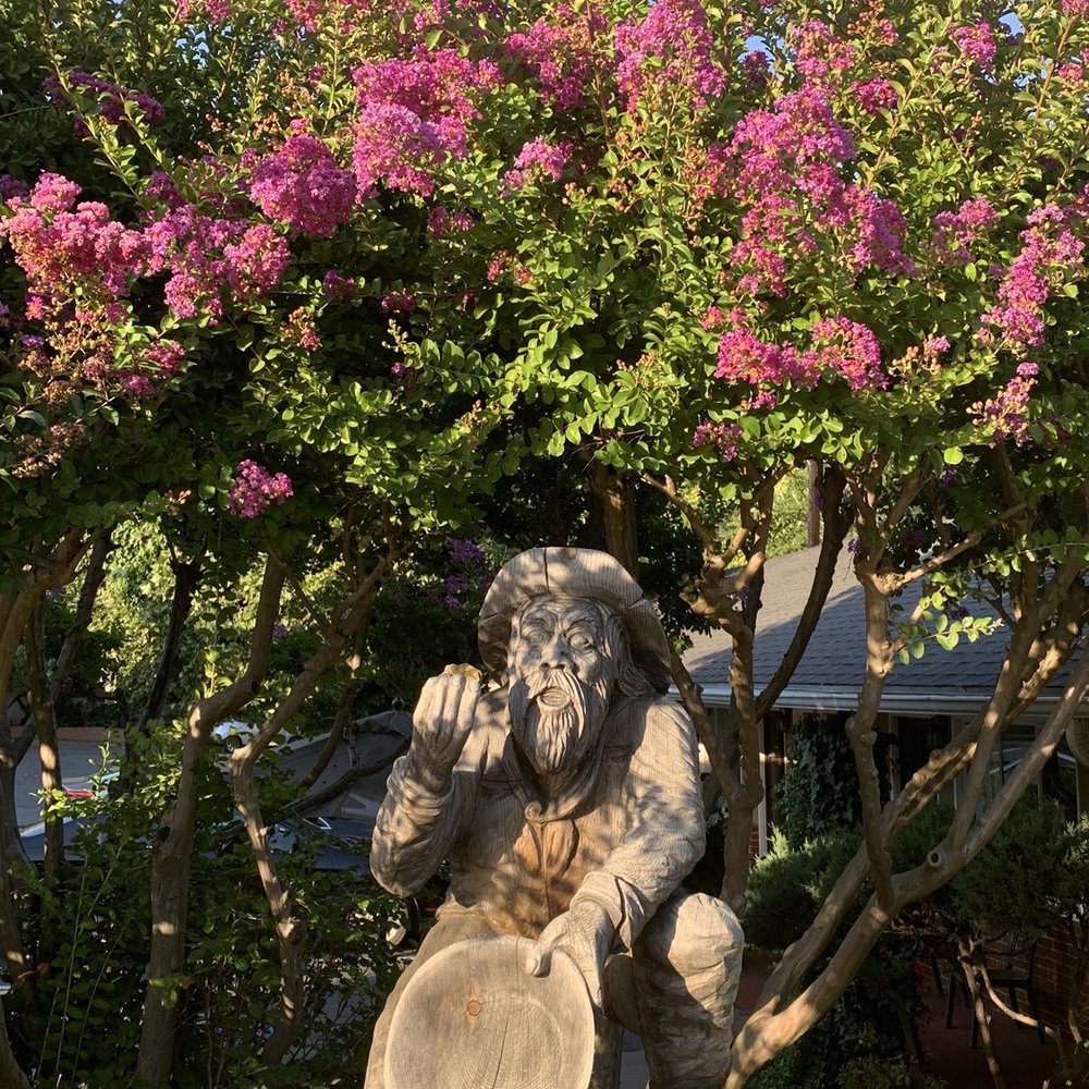 Pretty flowers and gold miner statue out front