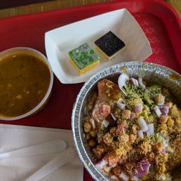Samosa chaat, chana masala and almond based sweets Samosa chaat, chana masala and almond based sweets