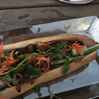 Hughie's - Pork banh mi and small peanut sauce and small fish sauce containers - Vietnamese Near Me - Houston, Texas Hughie's - Pork banh mi and small peanut sauce and small fish sauce containers - Vietnamese Near Me - Houston, Texas