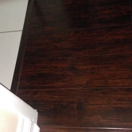Laminate floor w/trim separating restroom from bedroom Laminate floor w/trim separating restroom from bedroom