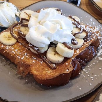 Egg Harbor Café - French toast with banana, chocolate drizzle, powdered sugar and whipped cream - Breakfast & Brunch Near Me - Elmhurst, Illinois Egg Harbor Café - French toast with banana, chocolate drizzle, powdered sugar and whipped cream - Breakfast & Brunch Near Me - Elmhurst, Illinois