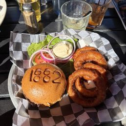 Cheddar cheese hamburger with onion rings and house Margarita. Delicious!!!