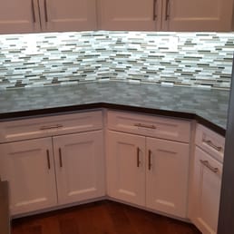 Extended countertop space, modern mosaic backsplash & highly functional cabinets & pullout drawers with decorative handles, hardwood floors