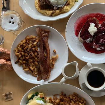 Egg - Top down: Barbacoa and Grits, French Toast, breakfast potatoes and bacon, and the Cornbread Benedict. Also boozie coffee: Espresso Martini - Breakfast & Brunch Near Me - Saint Louis, Missouri