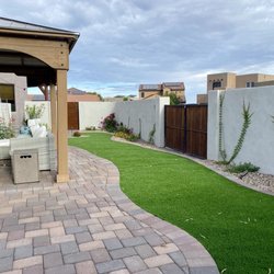 Man of the Soil Landscape Builder - The built wall, turf added, patio, gazebo, and plants all added by Ben's super crew! They even used our old door for fence to save on cost.