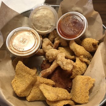 Captain John's - Trio Seafood Sampler. Catfish bites, butterfly shrimp and a crab cake. - Cajun/Creole Near Me - McAlester, Oklahoma