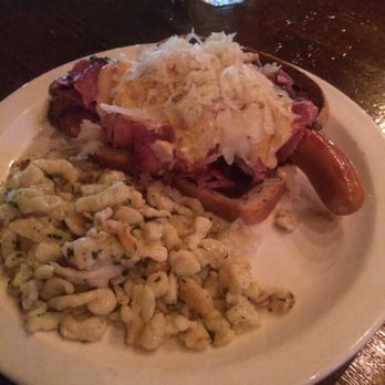 Biergarten - The Rottweiler (a house beef/pork frankfurter topped w/shaved pastrami, bier cheese &imported sauerkraut) w/Herbed Spaetzle - German Near Me - Boca Raton, Florida
