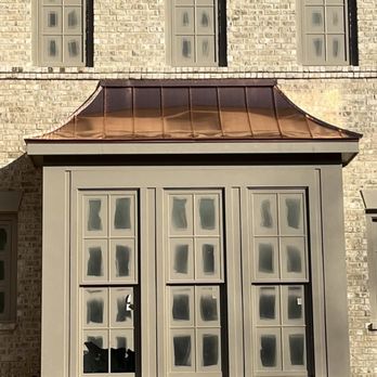 Arrow Building System - a brick building with a copper roof - Gutter Services Near Me Arrow Building System - a brick building with a copper roof - Gutter Services Near Me
