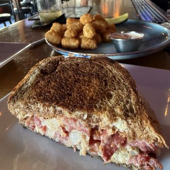 The Brixton - Reuben with tater tots (only half sandwich showing). - Gastropubs Near Me - Santa Monica, California The Brixton - Reuben with tater tots (only half sandwich showing). - Gastropubs Near Me - Santa Monica, California