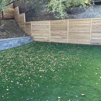 TateBuilt - Backyard with fence along slope. - Fences & Gates Near Me