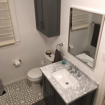 VIP Remodeling - Custom wood cabinets, cement tile, and Carrara marble vanity counter. - General Contractors Near Me