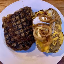 Medium rare ribeye with a loaded baked potato! Yum Medium rare ribeye with a loaded baked potato! Yum
