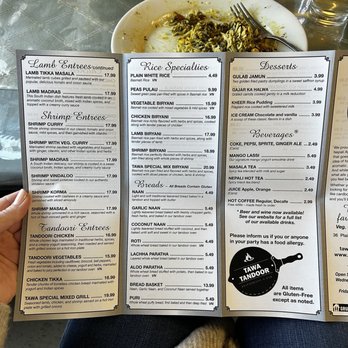 Tawa Tandoor Restaurant - a person holding a menu - Desserts Near Me - Haverhill, Massachusetts