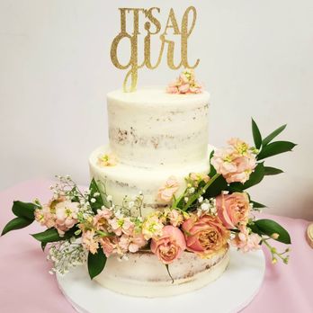 Dessert Lair - a three tiered cake with flowers - Desserts Near Me
