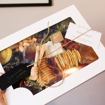 The Cheese Board Orange County - a person holding a box of cheese - Food Delivery Services Near Me The Cheese Board Orange County - a person holding a box of cheese - Food Delivery Services Near Me