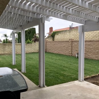 CJL Construction - After photo view of backyard from patio of retaining wall with new sod, sprinkler, and drainage system installed. - General Contractors Near Me - Riverside, California CJL Construction - After photo view of backyard from patio of retaining wall with new sod, sprinkler, and drainage system installed. - General Contractors Near Me - Riverside, California
