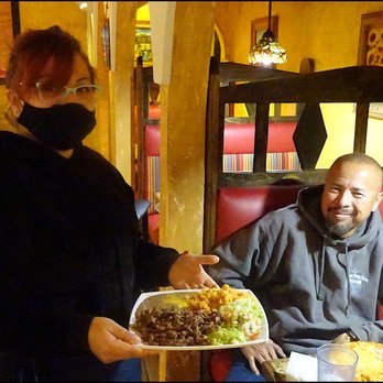 Burrito Grande - Our amazingly friendly server, Fabi, brings my plate of "Don Carlos Carne Asada" to the table, behind a masked smile. - Mexican Near Me - Roy, Utah Burrito Grande - Our amazingly friendly server, Fabi, brings my plate of "Don Carlos Carne Asada" to the table, behind a masked smile. - Mexican Near Me - Roy, Utah