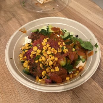 CAVA - Ordered with no corn and vinaigrette dressing on the side. Came with corn and harissa sauce mixed in. - Salad Near Me - El Segundo, California