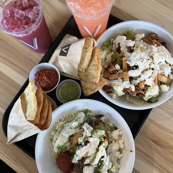 CAVA - two bowls of food and a drink on a tray - Salad Near Me - Fayetteville, Arkansas CAVA - two bowls of food and a drink on a tray - Salad Near Me - Fayetteville, Arkansas