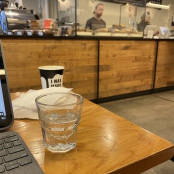 Seven Grams Caffe - a laptop and a glass of water - Coffee & Tea Near Me - New York, New York Seven Grams Caffe - a laptop and a glass of water - Coffee & Tea Near Me - New York, New York