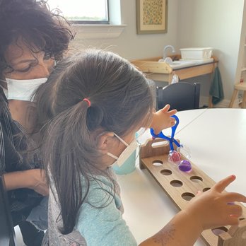 El Nido - Learning how to use the scooper - Montessori Schools Near Me - Missouri City, Texas El Nido - Learning how to use the scooper - Montessori Schools Near Me - Missouri City, Texas
