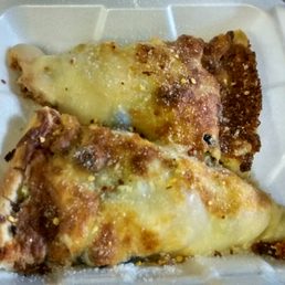 two slices of pizza in a styrofoam container