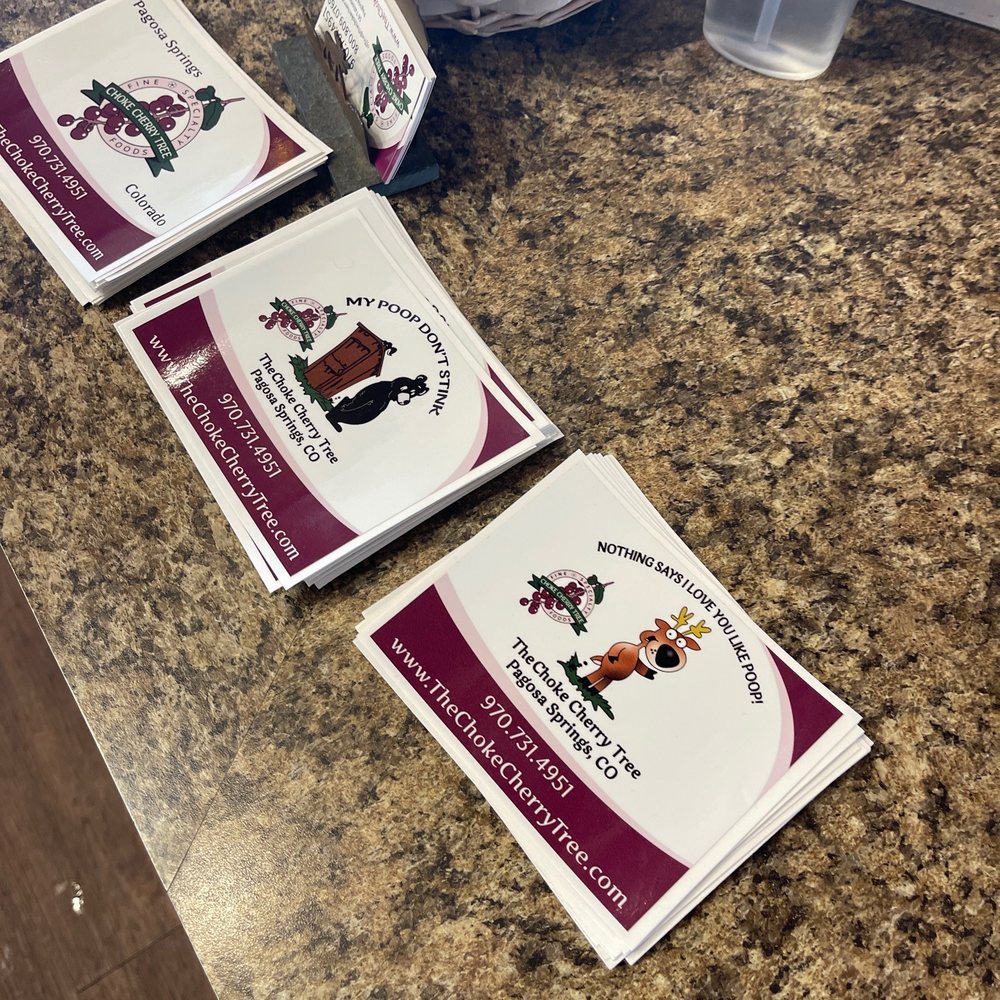 three business cards on a counter three business cards on a counter