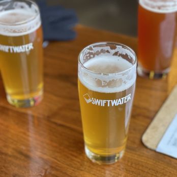 Swiftwater Brewery - three glasses of beer on a table - New American Near Me - Rochester, New York