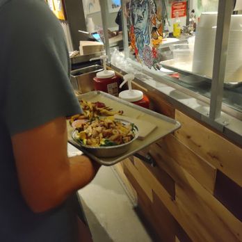 The Den by FoxGardin - a man holding a tray of food - Gastropubs Near Me - Carmel, Indiana The Den by FoxGardin - a man holding a tray of food - Gastropubs Near Me - Carmel, Indiana