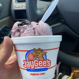 a hand holding a cup of ice cream a hand holding a cup of ice cream