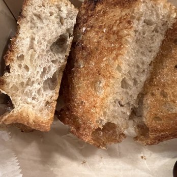 Pizza Grace - One slice of garlic bread cut into sections to share. The airy texture of the bread is contrasted with the crispy outside. Delicious! - Pizza Near Me - Birmingham, Alabama