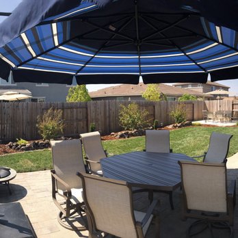 Lemos Landscape Inc. - a patio with a table and umbrella - Landscaping Near Me - Roseville, California Lemos Landscape Inc. - a patio with a table and umbrella - Landscaping Near Me - Roseville, California