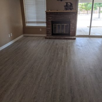 USA Carpet and Tile - a living room with a fireplace - Flooring Near Me - Victorville, California USA Carpet and Tile - a living room with a fireplace - Flooring Near Me - Victorville, California