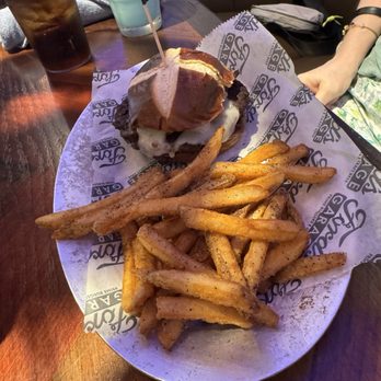 Ford's Garage Viera - Mushroom Swiss burger with pretzel bun and French fries - Bars Near Me - Melbourne, Florida Ford's Garage Viera - Mushroom Swiss burger with pretzel bun and French fries - Bars Near Me - Melbourne, Florida